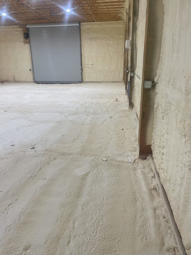 Interior of commercial building with spray foam insulation applied to walls and ceiling for energy efficiency