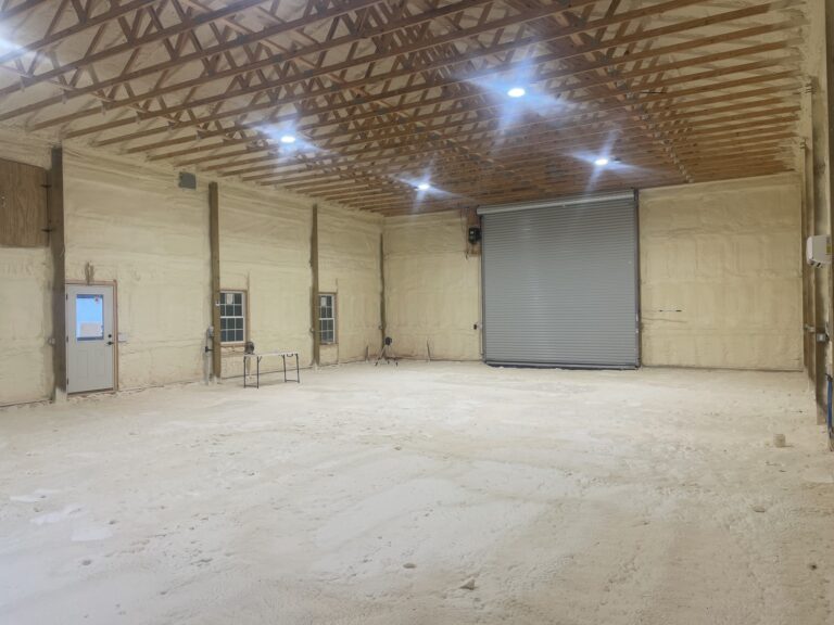 Interior of commercial building with spray foam insulation applied to walls and ceiling for energy efficiency